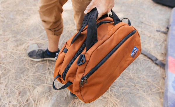 A person carrying the Old School Carry All by its handles